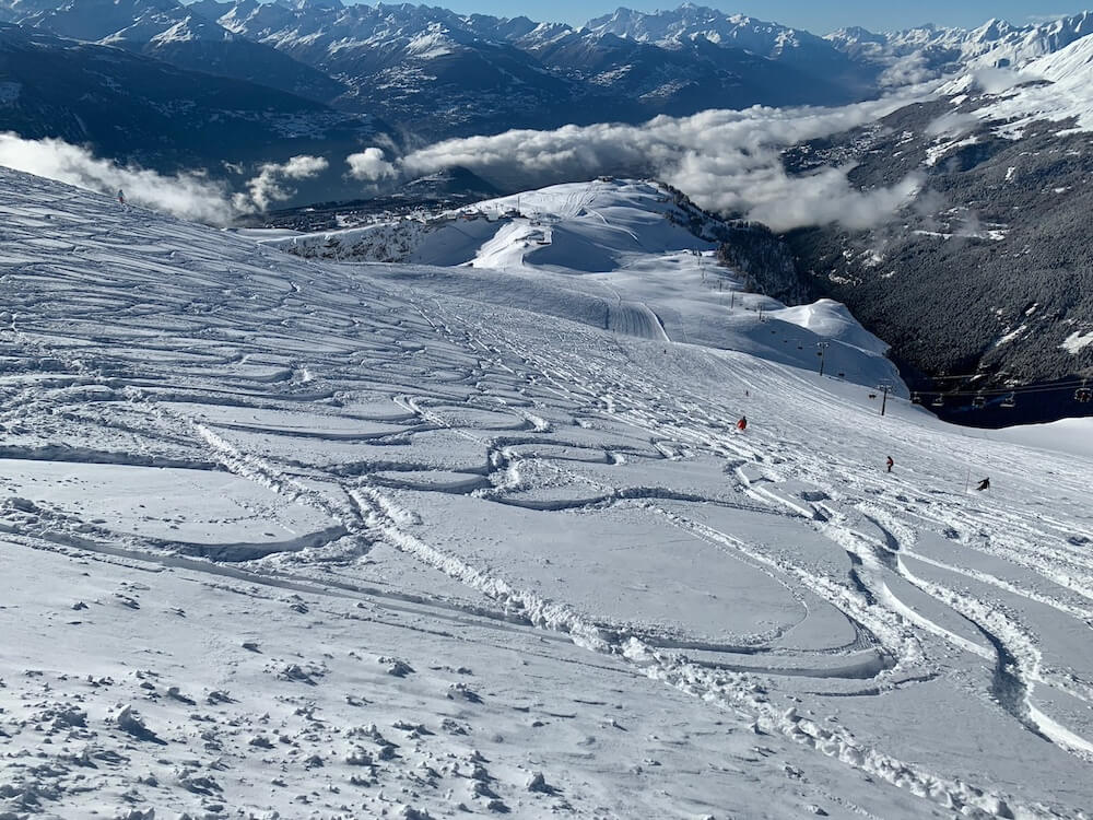 fresh tracks in powder and the view from bellalui in crans montana